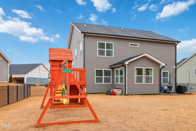 rear view of house with a playground