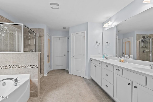 bathroom with tile patterned flooring, vanity, and plus walk in shower
