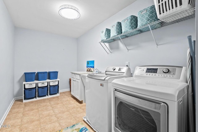 washroom featuring independent washer and dryer and cabinets