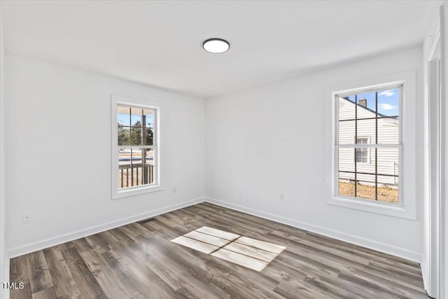 unfurnished room featuring dark hardwood / wood-style flooring