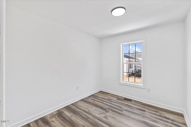 spare room with wood-type flooring