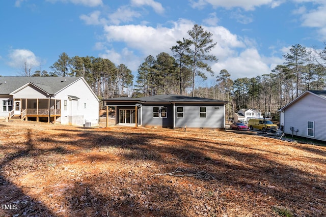 rear view of house featuring a sunroom