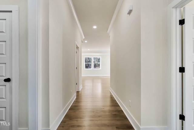 corridor featuring crown molding and dark hardwood / wood-style flooring