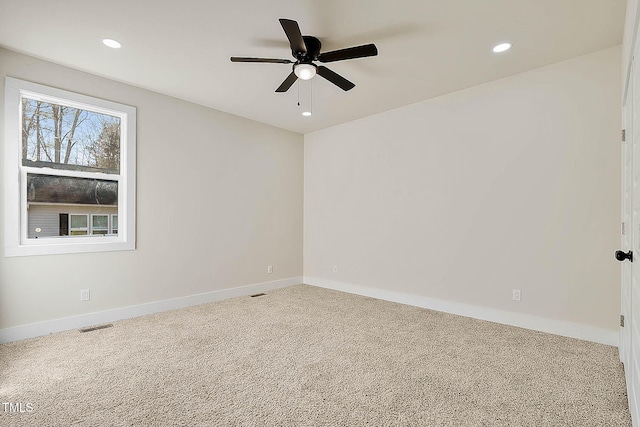 carpeted spare room with ceiling fan