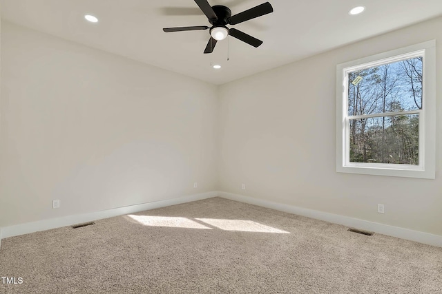 unfurnished room featuring ceiling fan and carpet flooring