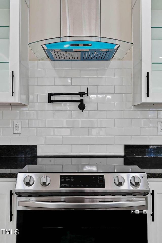 kitchen with island exhaust hood, white cabinets, and stainless steel electric range