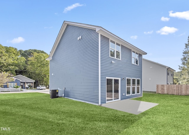 back of house featuring a patio, a yard, and central AC unit