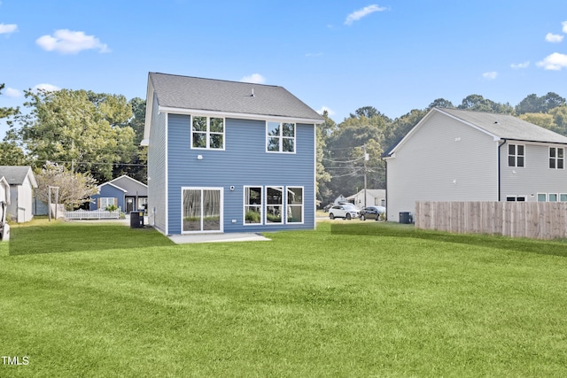 back of property with a yard, central AC unit, and a patio