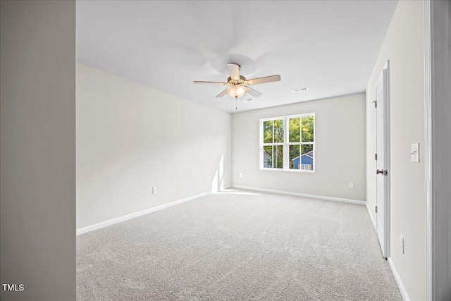 carpeted spare room featuring ceiling fan