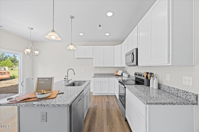 kitchen featuring white cabinetry, sink, a center island with sink, and appliances with stainless steel finishes