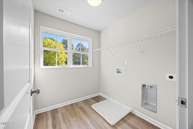 laundry room with washer hookup, hookup for an electric dryer, and light hardwood / wood-style flooring