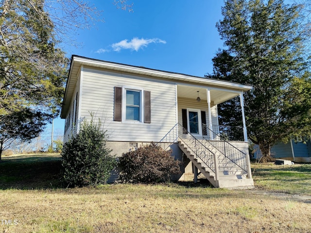 view of front of house with a porch and a front yard