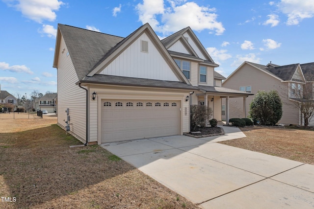 view of front of house featuring a shingled roof, an attached garage, board and batten siding, a front yard, and driveway