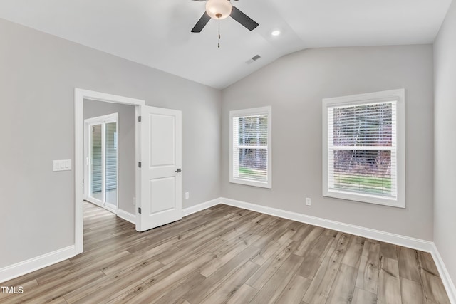 empty room featuring light wood-type flooring, vaulted ceiling, and ceiling fan