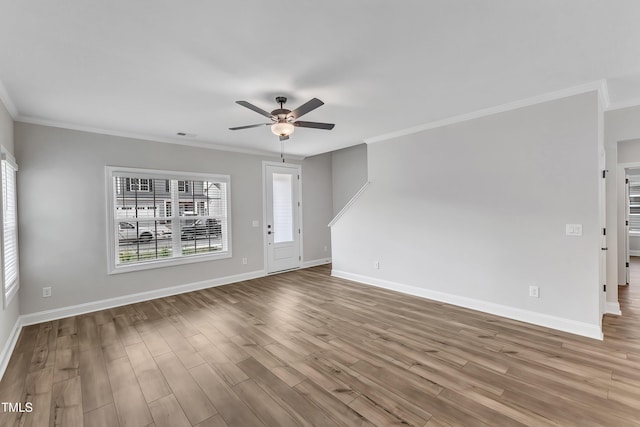 empty room with ceiling fan, light hardwood / wood-style flooring, and crown molding