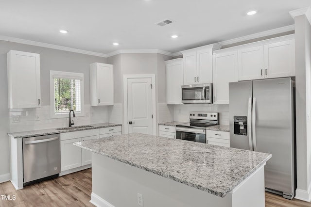 kitchen featuring white cabinets, appliances with stainless steel finishes, and a kitchen island