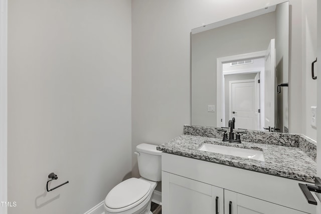 bathroom with toilet and vanity