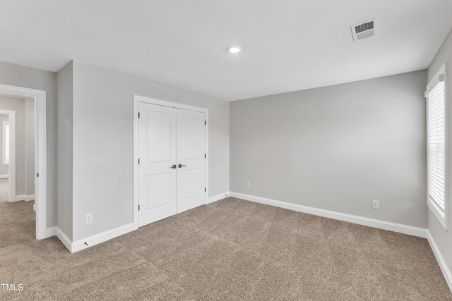 unfurnished bedroom featuring a closet and carpet