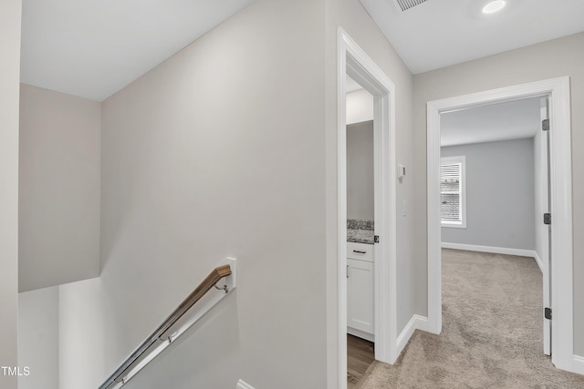 hallway with light colored carpet