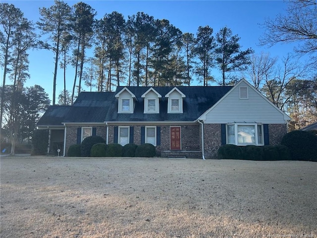 new england style home with a front lawn