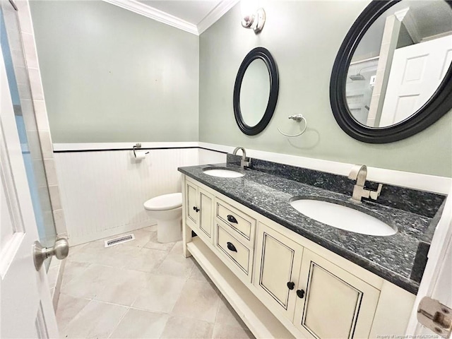 bathroom with vanity, crown molding, tile patterned floors, and toilet