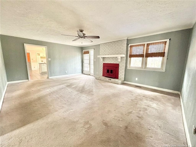 unfurnished living room with ceiling fan, light carpet, a fireplace, and a textured ceiling