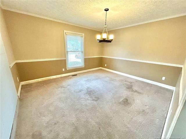 empty room with ornamental molding, carpet, and a textured ceiling