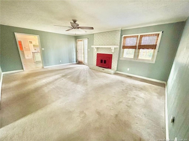 unfurnished living room with ceiling fan, carpet flooring, a textured ceiling, and a fireplace