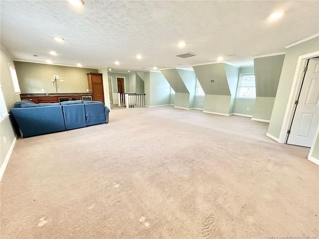 unfurnished living room with crown molding, light carpet, and a textured ceiling