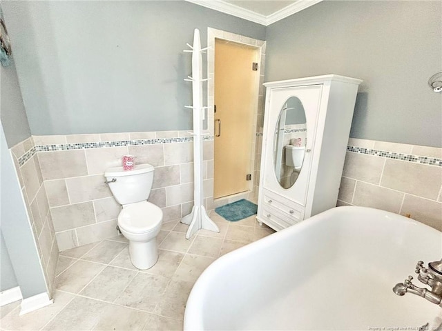 bathroom with crown molding, tile patterned floors, toilet, and tile walls