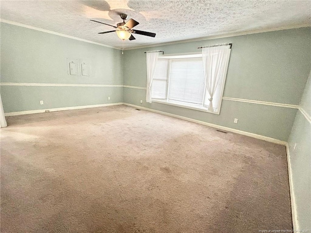 unfurnished room with ornamental molding, carpet, ceiling fan, and a textured ceiling