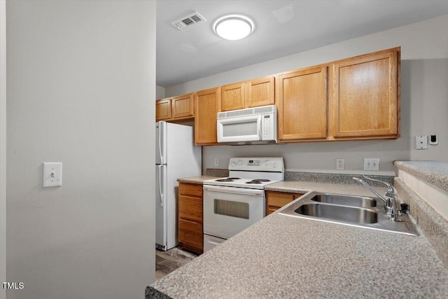 kitchen with sink and white appliances