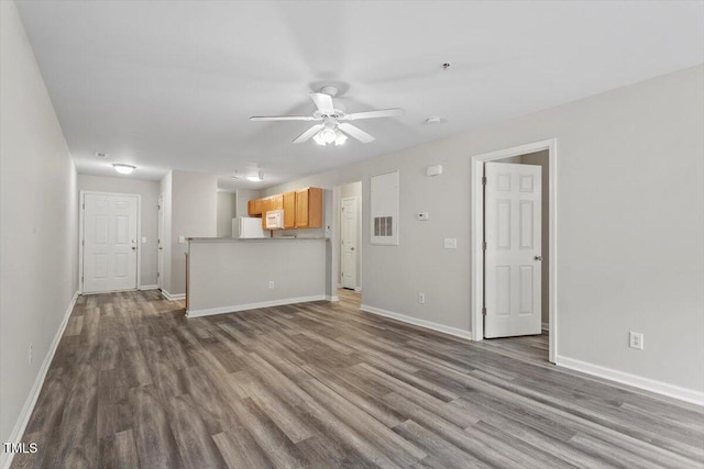 unfurnished living room with dark hardwood / wood-style flooring and ceiling fan