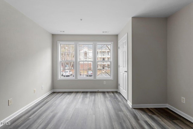 unfurnished room featuring hardwood / wood-style floors