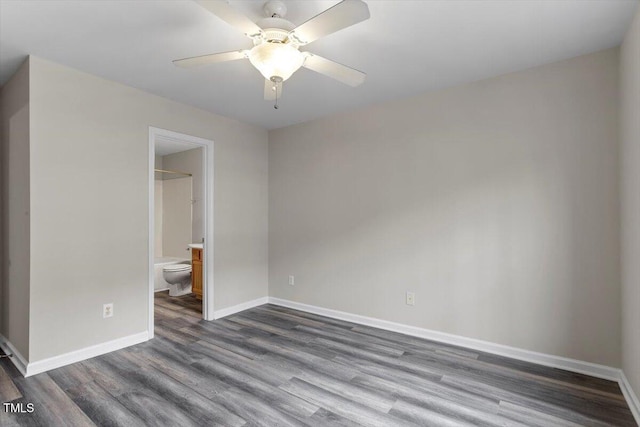 empty room with dark wood-type flooring and ceiling fan