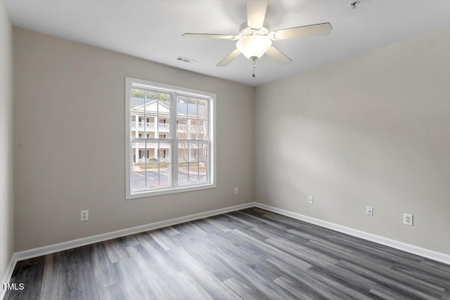 spare room featuring hardwood / wood-style flooring and ceiling fan