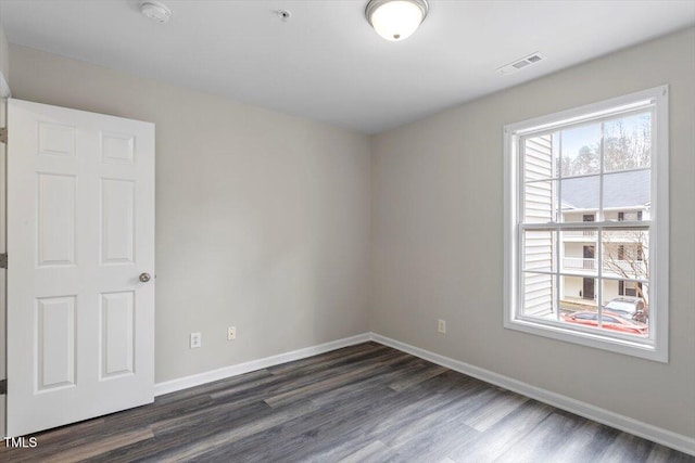 empty room featuring dark wood-type flooring