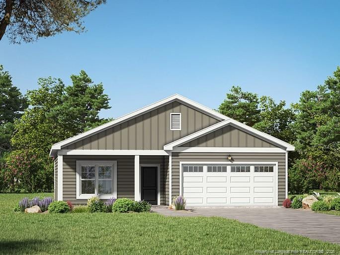 view of front of property with a garage and a front yard