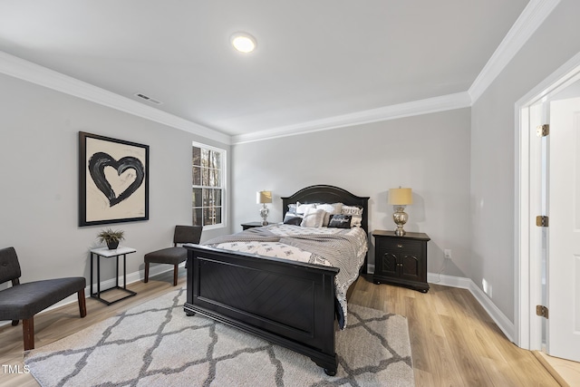 bedroom with ornamental molding and light wood-type flooring