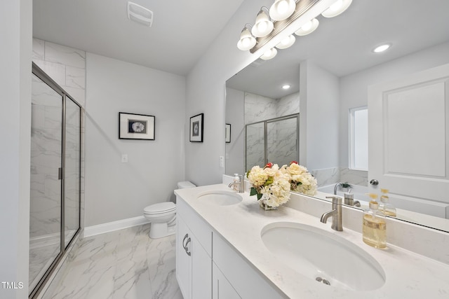 bathroom with vanity, toilet, and a shower with door