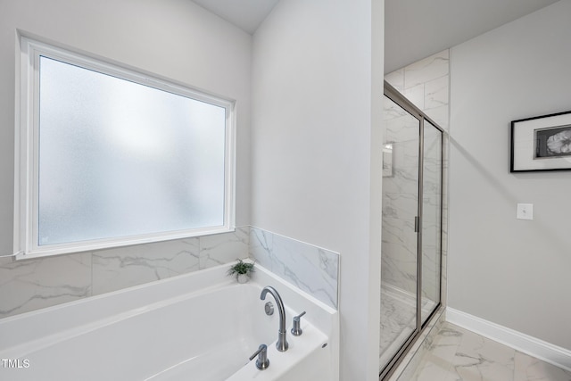 bathroom featuring shower with separate bathtub and a healthy amount of sunlight