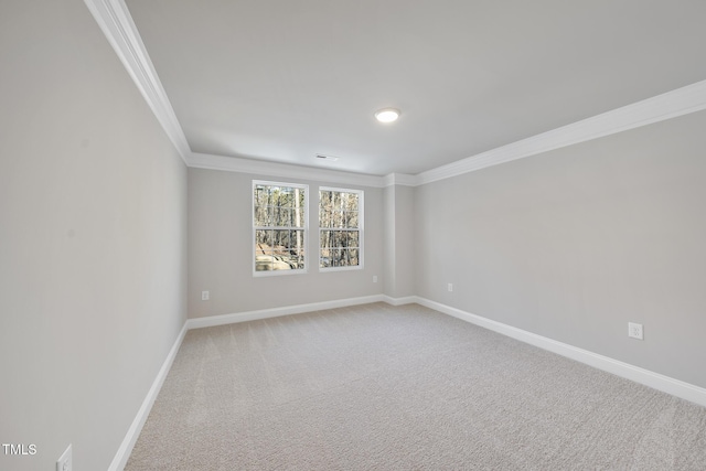 carpeted empty room featuring crown molding