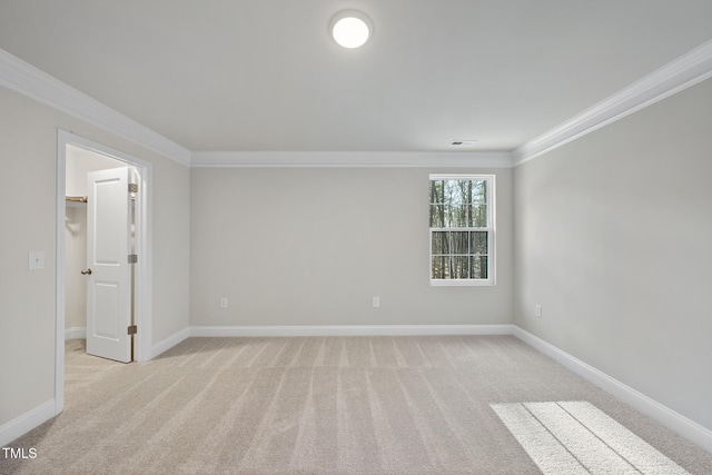 unfurnished room with crown molding and light carpet