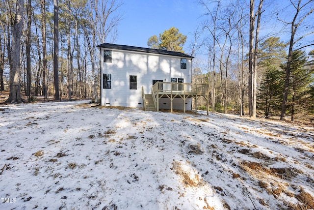 snow covered house with a deck