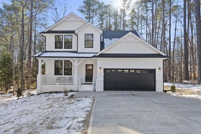 modern inspired farmhouse with a garage and covered porch