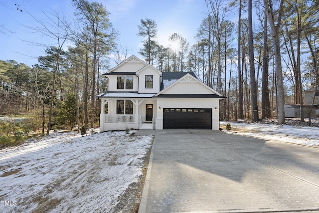 modern farmhouse featuring a porch and a garage