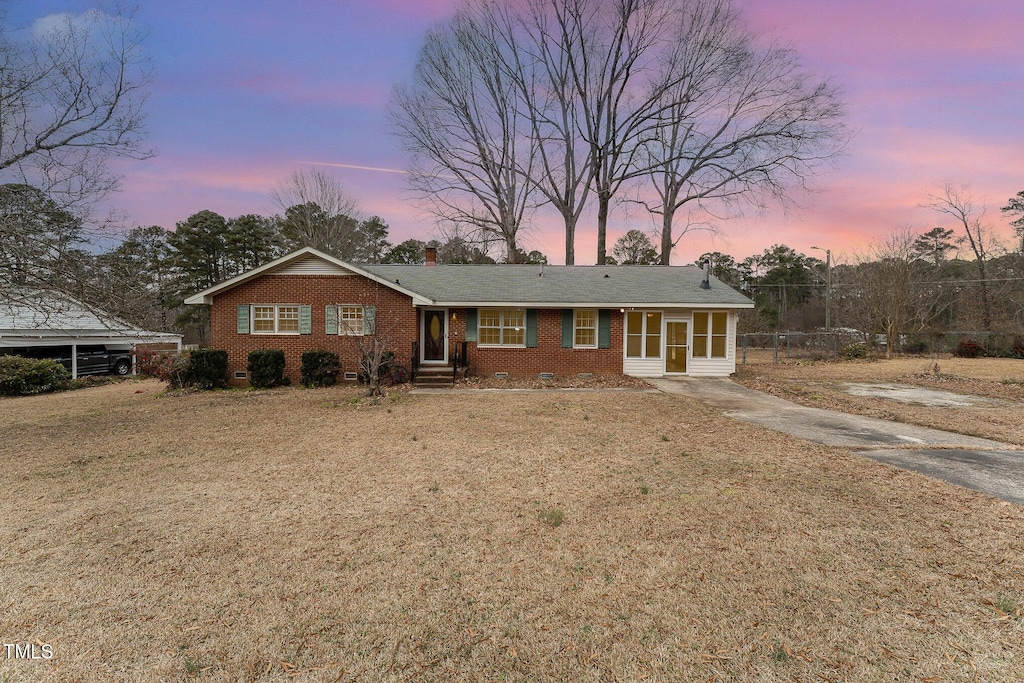 ranch-style house with a lawn