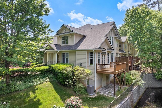 rear view of property with central AC unit, roof with shingles, a wooden deck, and fence