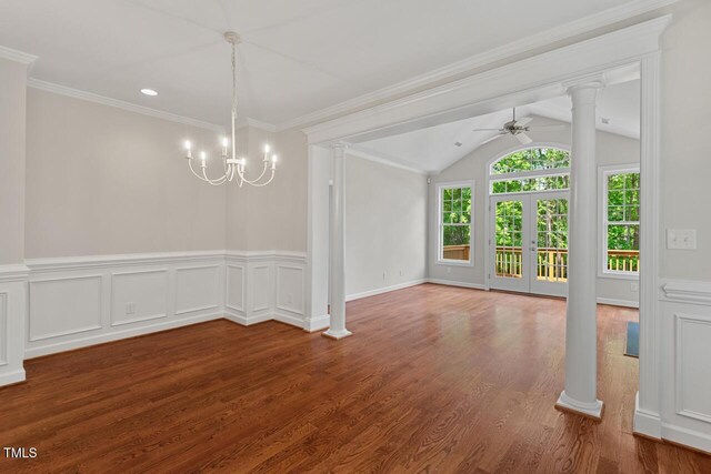 unfurnished dining area featuring decorative columns, lofted ceiling, wood finished floors, and ceiling fan with notable chandelier