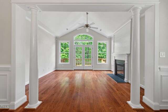 unfurnished living room with a fireplace with flush hearth, a ceiling fan, and light wood finished floors